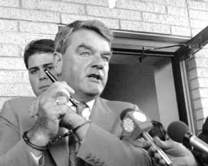 Irving in handcuffs with officers
